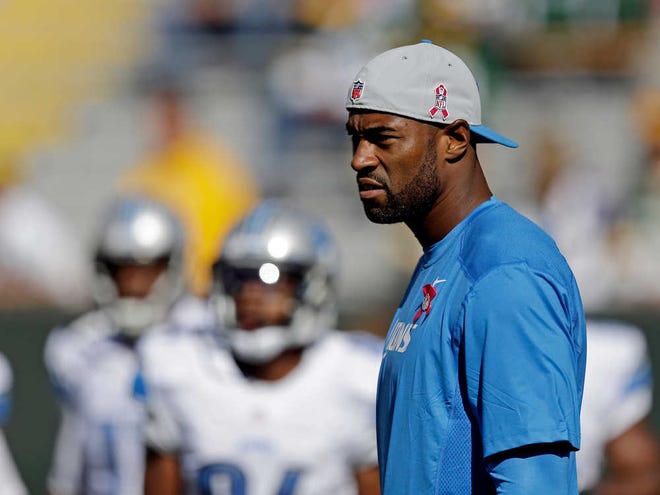 Detroit Lions wide receiver Calvin Johnson watches as his teammates warm up before an NFL football game against the Green Bay Packers Sunday, Oct. 6, 2013, in Green Bay, Wis. Johnson had been sidelined two days last week with a knee injury and was declared inactive for Sunday's game. (AP Photo/Jeffrey Phelps)