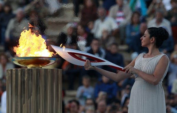 Preparing for Sochi:                Actress Ino Menegaki, playing the role of a high priestess, lights the torch with the Olympic flame during a handover ceremony in Athens. The flame was handed to organizers of the Sochi Winter Olympics in a ceremony at the site of the first modern summer games.