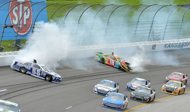 John Sleezer Kansas City Star Sprint Cup Series driver Kyle Busch (18) bounces off the wall as driver Brian Vickers (55) slides out of control during the Hollywood Casino 400 on Sunday at Kansas Speedway in Kansas City, Kan.