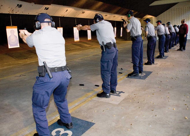 This photo provided by the Federal Law Enforcement Training Center shows gun training in February 2010 at an indoor shooting range in Glynco, Ga.