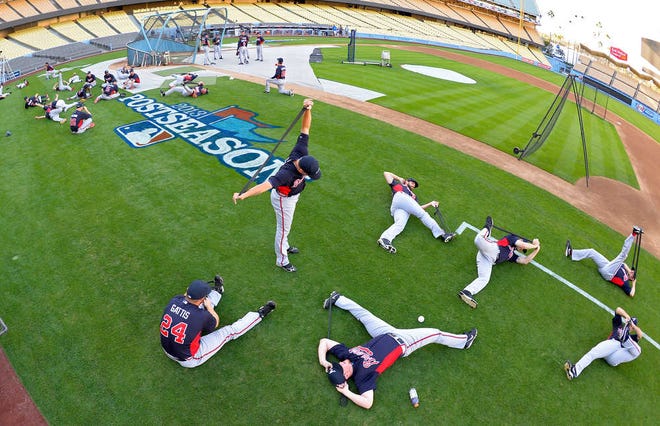 Members of the Atlanta Braves warm up during practice in preparation for Game 3 of the National League division series against the Los Angeles Dodgers, Saturday, Oct. 5, 2013, in Los Angeles. (AP Photo/Mark J. Terrill)