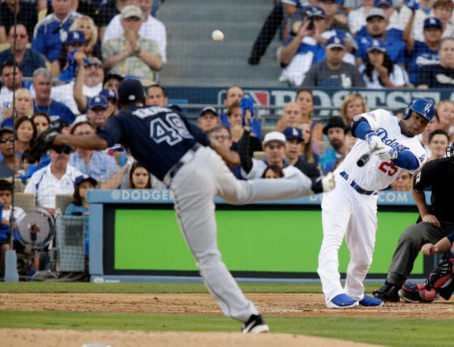 Los Angeles' Carl Crawford hits a three-run home run off of Atlanta starting pitcher Julio Teheran during the second inning. The Dodgers stormed back after the Braves took a 2-0 lead and cruised to a win Sunday night.