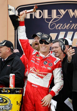 Driver Kevin Harvick celebrates in victory lane after winning the Hollywood Casino 400 NASCAR Sprint Cup series auto race at Kansas Speedway in Kansas City, Kan. on Sunday.