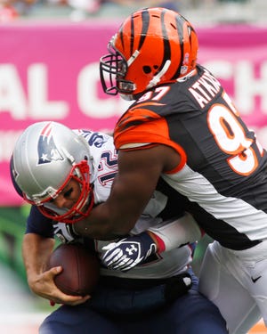 New England Patriots quarterback Tom Brady (12) is sacked by Cincinnati Bengals defensive tackle Geno Atkins during Sunday’s NFL game in Cincinnati.