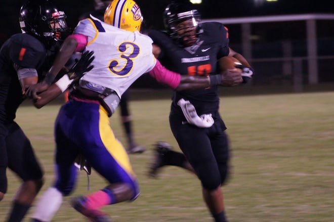 DHS running back Henry Broden pushes off an Independence defender in the team’s 14-6 win Friday night in Donaldsonville.