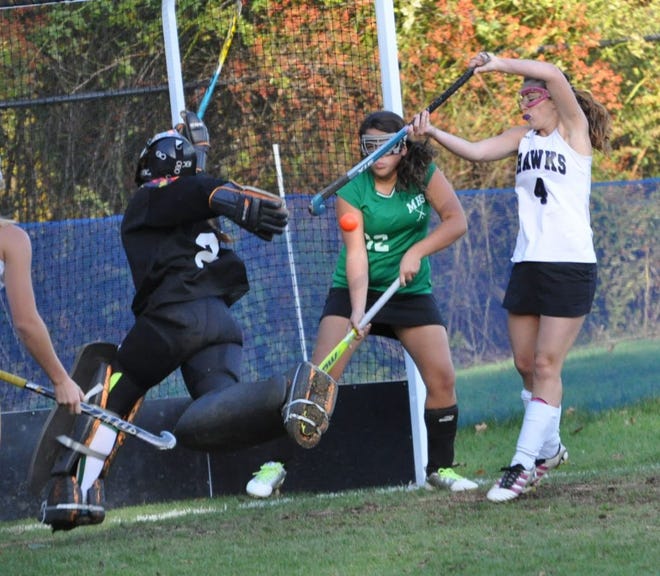 Marshwood’s Haley Horton, right, tries to get her stick on a loose ball in front of the Massabesic goal with Massabesic’s Ashley Rondeau and goalie Abby Greenleaf during Western Maine Class A action Tuesday in South Berwick.