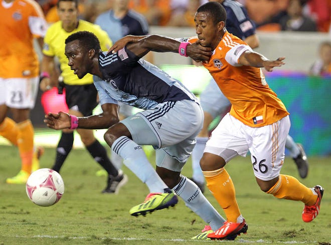 C.J. Sapong, left, and Sporting Kansas City tied 0-0 with Corey Ashe and the Houston Dynamo on Wednesday night.