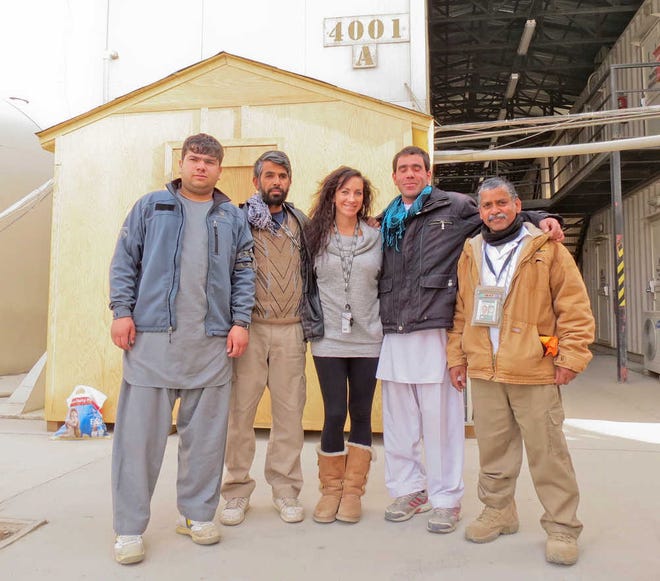 Jenny Jones stands with three Afghan cleaners and an Indian escort while stationed at Bagram Air Force Base. Jones said all Afghans must be escorted while on base.