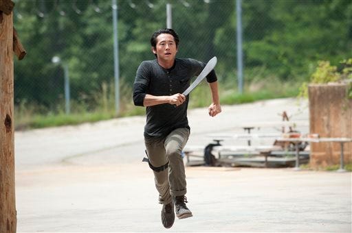 This image released by AMC shows Steven Yeun as Glenn in a scene from "The Walking Dead," premiering Oct. 13 at 9 p.m. EST.
