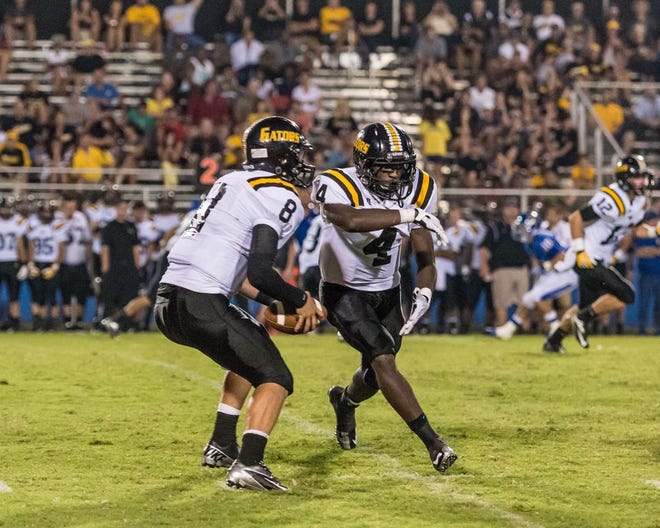 Quarterback Tyler Dixon (No. 8) and tailback Richard Williams (No. 4) have the Gator offense averaging 34 a game. Photo by Dewey Keller.