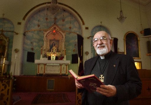 In this 2001 file photo, the Very Rev. S.G. Kasparian stands inside Saints Sahag & Mesrob Armenian Apostolic Church. The church is celebrating its 100th anniversary.