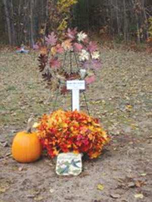 Chippewa County Sheriff Deputies are investigating the disappearance of this decorative wreath and large flower pot from the Holy Family Catholic Cemetery in Bruce Township.