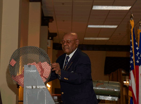Walter Faison, treasurer for the Samuel Council Chapter of the 555th Parachute Infantry Association, spins raffle tickets before a winner is drawn at the association’s 19th Annual Triple Nickle Scholarship Banquet, Sept. 28. The raffles are part of the association’s fundraising for their community service and scholarship program.