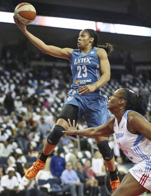 Moore than enough: The Lynx's Maya Moore goes in for a layup over Le'coe Willingham of the Atlanta Dream during Game 3 of the WNBA Finals in Duluth, Ga. Moore scored 23 points, and Minnesota won 86-77 to sweep the three-game series.