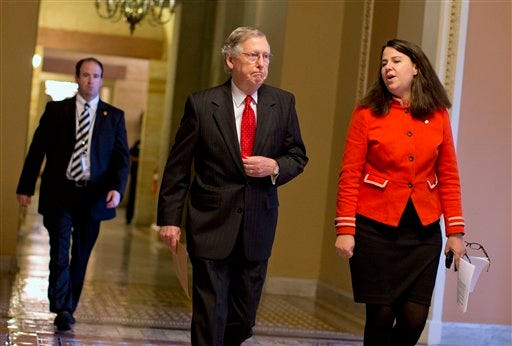 Senate Minority Leader Mitch McConnell of Ky., center, talks with Laura Dove, Secretary for the Minority of the Senate, as they walk to the Senate floor on Capitol Hill in Washington, Friday, Oct. 11, 2013, ahead of a meeting with President Obama at the White House.