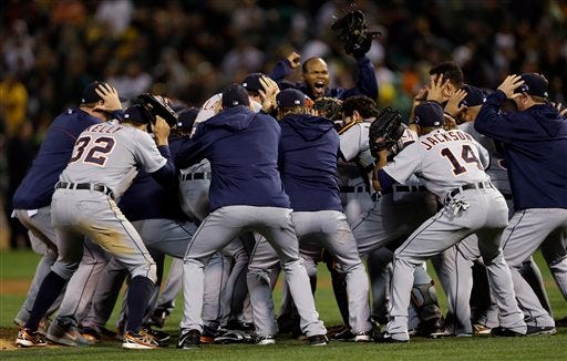 The Detroit Tigers celebrate after beating the Oakland Athletics 3-0 in to win Game 5 of an American League baseball division series in Oakland, Calif., Thursday, Oct. 10, 2013. (AP Photo/Marcio Jose Sanchez)