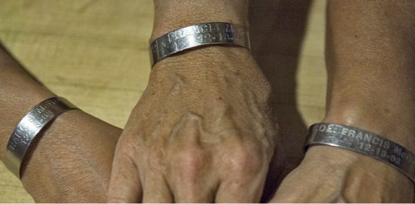 Even after the remains of their father, Air Force Col. Francis Jay McGouldrick, were recovered, the McGouldrick sisters continue to wear bracelets bearing his name.