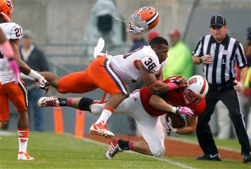 Syracuse's Cameron Lynch (38) tackles North Carolina State's Tyler Purvis, right, during the second half on Saturday at Carter-Finley Stadium in Raleigh.