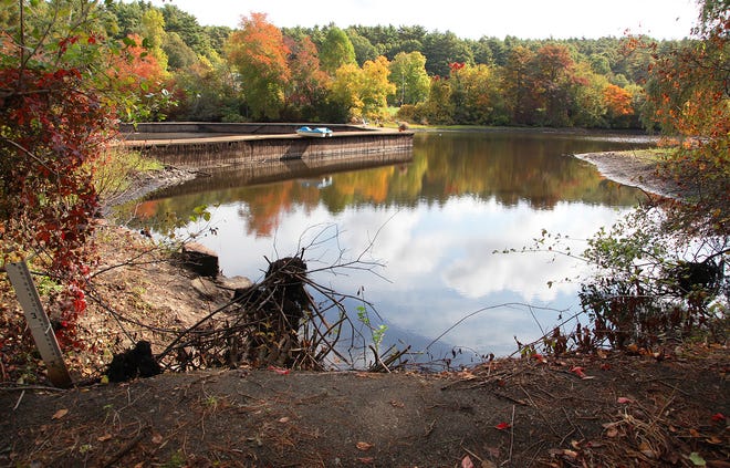 A dam at Chandler's Pond in Marshfield has neighbors at odds at water levels fall Oct. 4, 2013.