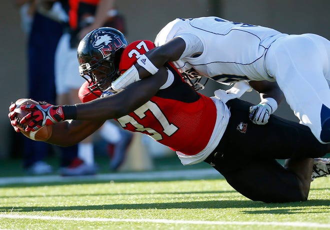Northern Illinois tight end Desroy Maxwell stretches the ball over the goal line for a touchdown as Akron cornerback Emmanuel Lartey tries to make the tackle during the first half Saturday, Oct. 12, 2013, in DeKalb.