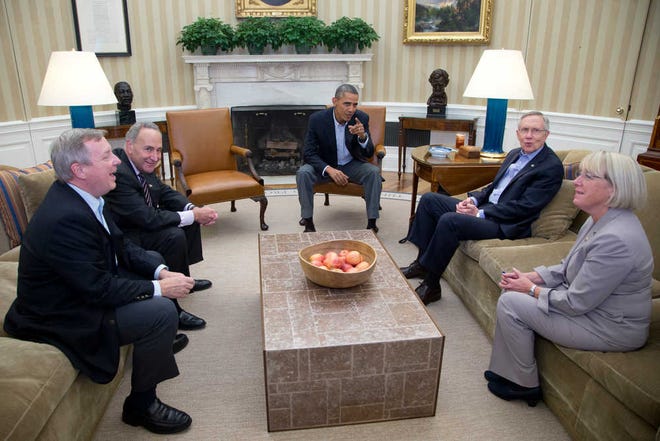 From left, Sen. Dick Durbin, D-Ill., Sen. Charles Schumer, D-N.Y., President Barack Obama, Senate Majority Leader Harry Reid of Nev., Sen. Patty Murray, D-Wash., look to photographers as they meet in the Oval Office of the White House, Saturday, Oct. 12, 2013, in Washington. The federal government remains partially shut down and faces a first-ever default between Oct. 17 and the end of the month. (AP Photo/Carolyn Kaster)
