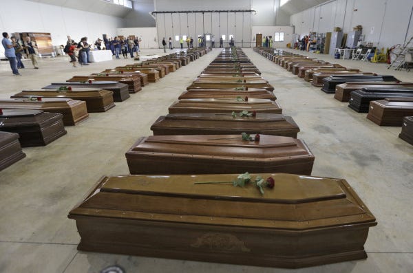 Coffins containing the bodies of migrants who drowned off the coast of Lampedusa island on Oct. 3 wait in an airport hanger. Two more ships full of migrants fleeing Africa sank in the Mediterranean on Friday, leaving at least 46 refugees dead.