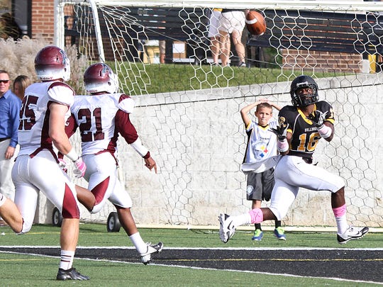 Adrian College receiver Tyler Bruce, right, sets his sights on a 23-yard touchdown pass from Aaron Tenney in Saturday’s MIAA win over Alma College on Saturday.