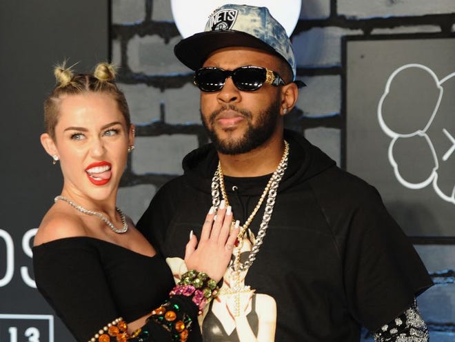 Miley Cyrus and Mike WiLL Made-It arrive for the MTV Video Music Awards at the Barclays Center in the Brooklyn borough of New York on Aug. 25. Mike WiLL Made-It, who executive- produced “Bangerz,” Cyrus’ new album, said the singer isn’t following in footsteps of pop stars like Katy Perry, but creating her own bold path.