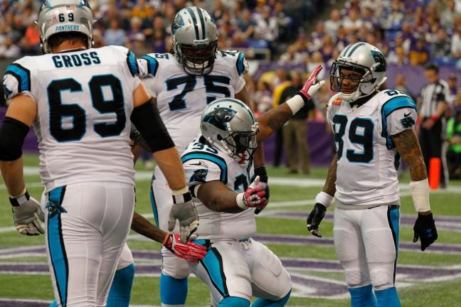 Mike Tolbert, center, dances with teammates after scoring a touchdown in the Panthers' 35-10 victory against the Vikings on Sunday.