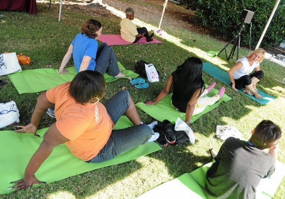 PATRICK KANE/PROGRESS-INDEX PHOTOS
Folks attending an open house at the Healthy Living and Learning Center in Petersburg participate in a free yoga class, led by Hope Lynch, Oct. 3, on the lawn of the Petersburg Public Library, William McKenney Branch, located at 137 S. Sycamore St.