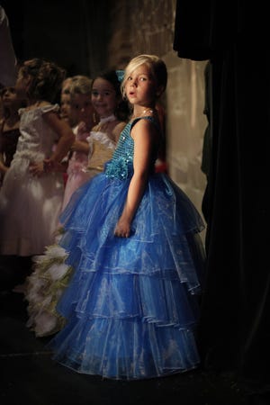 A girl attends the Mini Miss beauty contest in Paris on Sept. 28. France's Senate has voted to ban beauty pageants for children under 16. Anyone who enters a child into such a contest would face up to two years in prison and 30,000 euros ($40,000) in fines.