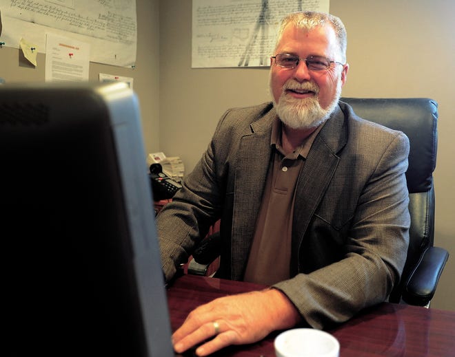 Jim Milleson at his desk in the Homeland Realty office in Freeport.