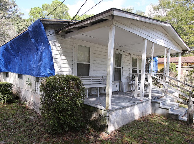 A tarp covers the entire roof of Ulysses Robinson's home on East 12th Street in Panama City.