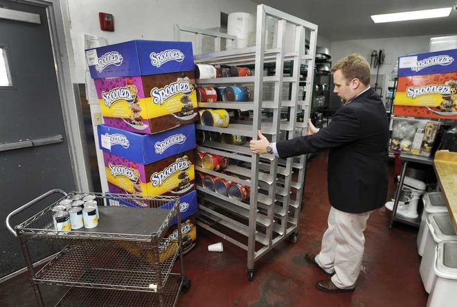 Bob.Self@jacksonville.com Kevin Carrico, vice president of operations for the Clara White Mission, looks at the rack that is usually filled with large canned goods in the facility's kitchen.
