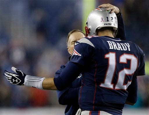 New England Patriots head coach Bill Belichick congratulates quarterback Tom Brady on his winning touchdown pass against the New Orleans Saints in the fourth quarter of Sunday's game. The Patriots won 30-27.