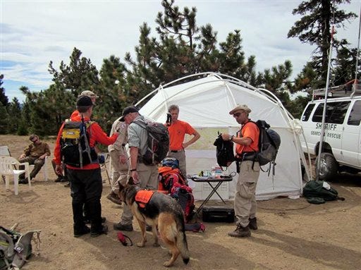 Volunteers and rescue workers gather before searching for missing hunter Gene Penaflor. Penaflor, a 72-year-old hunter who got hurt in a Northern California forest, was rescued Saturday, Oct. 12, 2013.