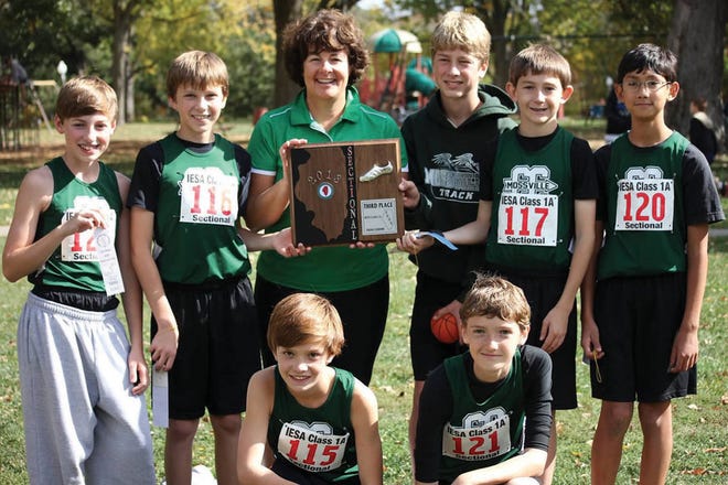 The Mossville Junior High cross country poses with the third-place plaque after finishing sectionals. Front row, from left, Colin Eissenbarth and Euan Price. Back row, from left, they are Noah Slater, Jordan Gerberding, coach Michele Stewart, Finnian Jetton, Owen Habeger and Michael Kupfer.