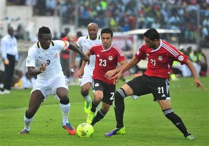 Ghana's Asamoah Gyan, left, battles with Egypt's Mohamed Naguib and Ahmed Shedid, right, during their World Cup playoff soccer match.