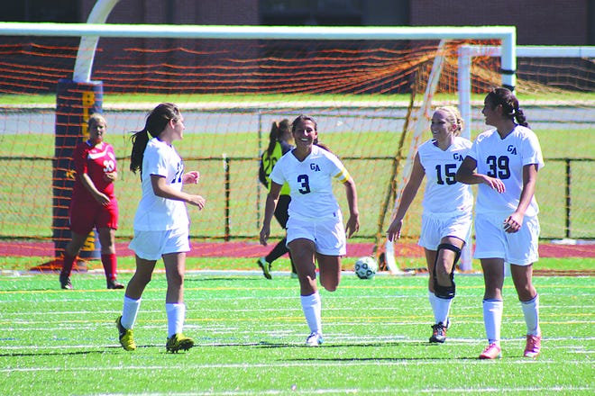 The Blue Devil girls’ soccer team celebrated a goal earlier in the season by senior Abbey Denkovich (3). Last week the squad clinched the division crown.