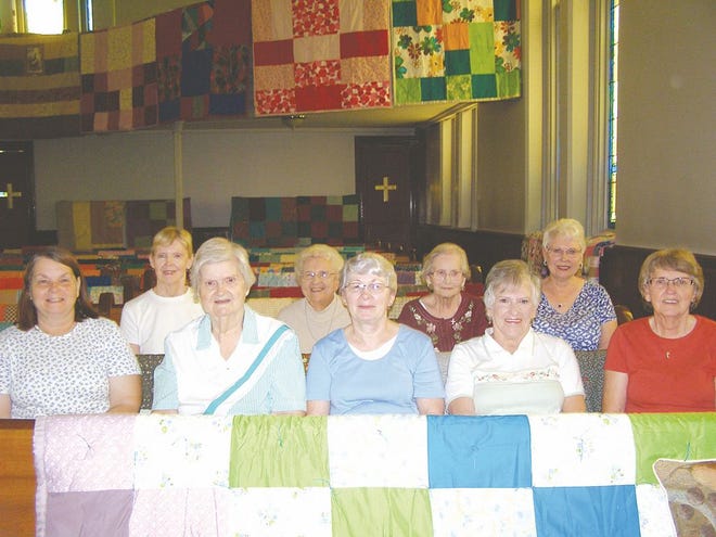 Hands of Love Quilters display the results of a year of labor. Pictured, from left, front row: Sue Miller, Dolores Burkholder, Linda Murray, Cecelia Hoyle, Lorraine Reeder. Back row: Joanne Eberly, Lucille Talhelm, Faye Mentzer, Judy Reed. Not pictured: Dolly Shoemaker, Joyce Elliott, Carolyn Kendle and Sue Resh.