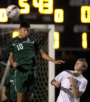 Ashbrook's Adolfo Henriquez, left, heads the ball over Forestview's Ross Boyd during their match Wednesday evening at Forestview High School.