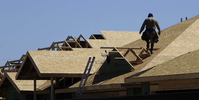 A man works on the roof of a new home in Odessa, Texas. Hundreds of houses are being built in the West Texas oil town.
AP PHOTO Pat Sullivan - AP