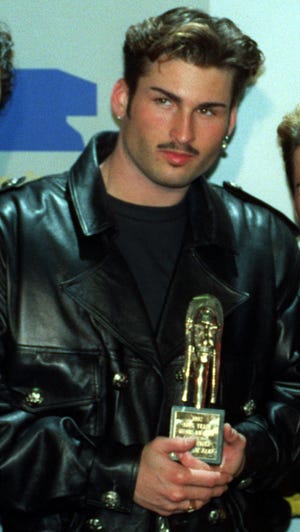 **FILE** Bryan Abrams poses backstage at the Sixth Annual Soul Train Awards where his group, "Color Me Badd," won an award for Best R&B/Soul Single by a Group, in Los Angeles, March 10, 1992. Abrams' ex-wife, Shon Gables, has filed a civil lawsuit against Abrams whom she alleges owes more than $16,000 in back child support. Gables, a former Oklahoma City newscaster who now anchors WCBS news in New York City, appeared in Oklahoma County District Court earlier this week. (AP Photo/Doug Pizac)