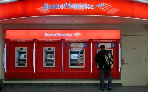 In this Dec. 13, 2012 photo, a customer stops at a Bank of America ATM office in Boston. Bank of America Corp. says it will spend more than $10 billion to settle mortgage claims resulting from the housing meltdown. Under the deal announced Monday, Jan. 7, 2013, the bank will pay $3.6 billion to Fannie Mae and buy back $6.75 billion in loans that the North Carolina-based bank and its Countrywide banking unit sold to the government agency from Jan. 1, 2000 through Dec. 31, 2008. That includes about 30,000 loans. (AP Photo/Charles Krupa)