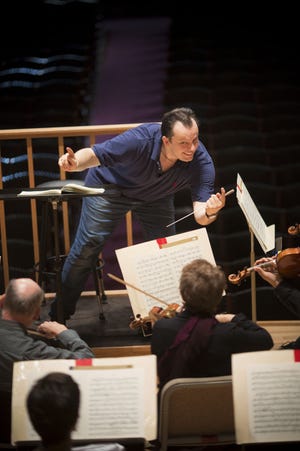 Andris Nelsons uses his body to express musical direction as he rehearses the Boston Symphony Orchestra on Tuesday, Oct. 15, 2013.