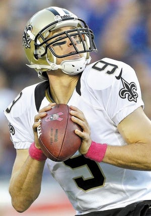 New Orleans Saints quarterback Drew Brees looks for a receiver against the New England Patriots in the first half of an NFL football game Sunday, Oct.13, 2013, in Foxborough, Mass. (AP Photo/Steven Senne) ORG XMIT: FBO121
