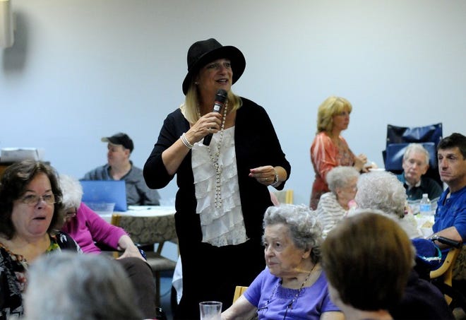 Judy Beck of Langhorne, a Center City tour guyde for City Food Tour in Philadelphia, speaks about Prohibition during the Wood River Village retirement community Roaring 20s "Dance" for its Personal Care Unit on Thursday night.