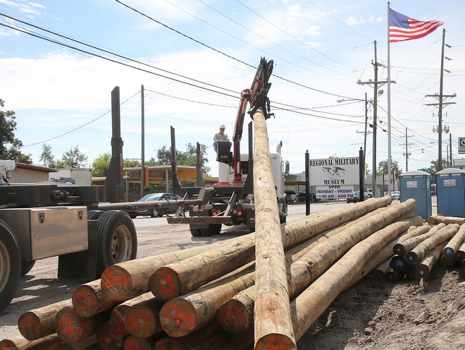 A worker moves pilings Friday at the Regional Military Museum’s new building on Barrow Street in Houma. Workers have been driving the foundation pilings this week for the new 12,000-square-foot building, which is expected to be completed by February.