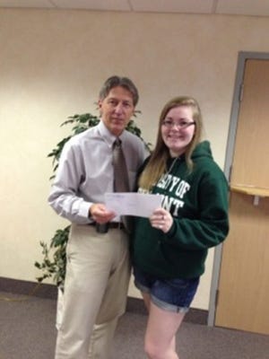 Dr. Mark Chag presents 2013 Portsmouth High School graduate Madelyn Schefer with a check for $1,000 from Harbour Women’s Health’s Charlene Easter Memorial Scholarship Fund. (Courtesy photo)