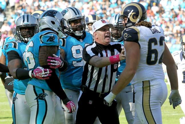 Carolina's Greg Hardy, left, and St. Louis' Harvey Dahl, right are seperated after they got into an altercation during the Panthers' 30-15 win over the Rams Sunday at Bank of America Stadium.